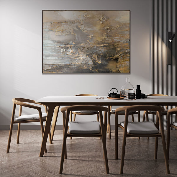 Modern dining room featuring a large abstract painting with gold and grey elements, enhancing the elegant atmosphere