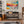 Modern living room with vibrant abstract wall painting and stylish decorative shelf arrangement.