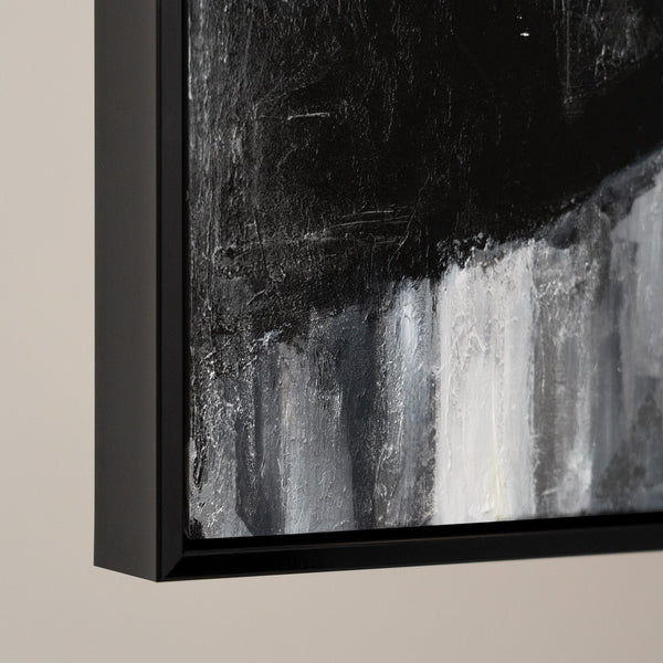 Abstract monochrome artwork in black frame, showcasing dark and light contrasts, perfect for modern decor