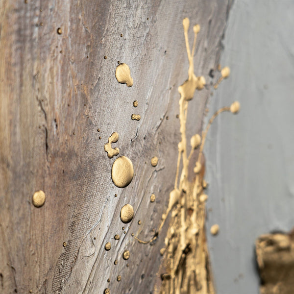 Detail of abstract gold splatter on a textured grey canvas, perfect for adding a modern touch to interior design